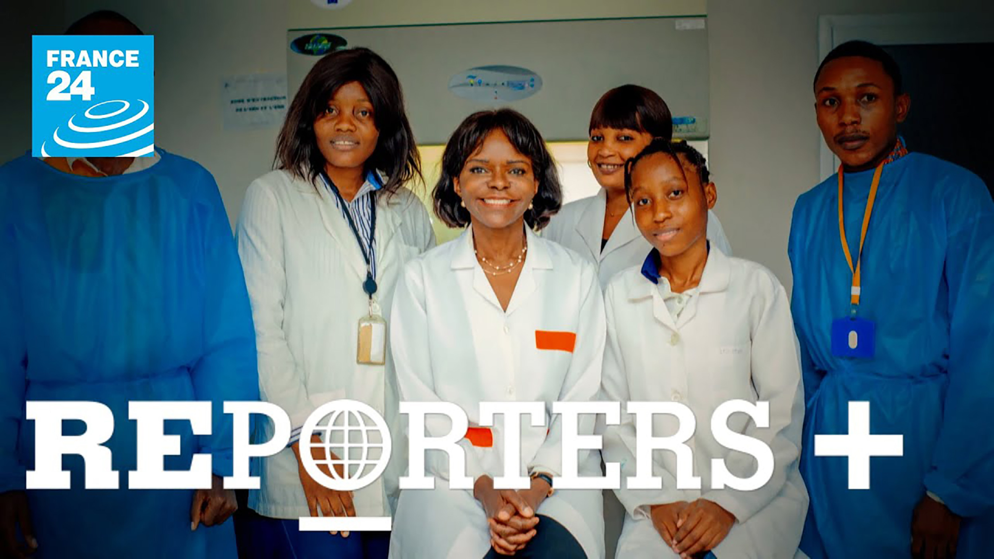 A group of six people, dressed in lab coats, poses for a photo. A "FRANCE 24" logo is positioned in the top-left corner. The words "REPORTERS +" are prominently displayed at the bottom of the image.